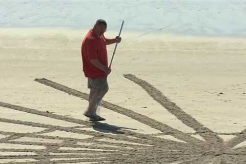 The sand artist Subby rakes masterpieces by the sea