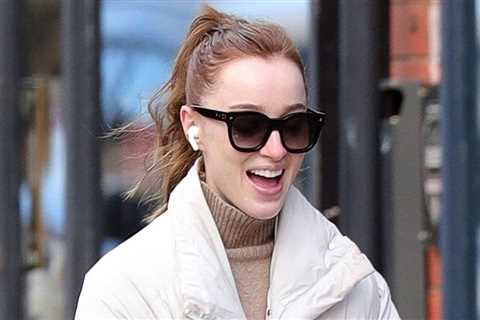 Phoebe Dynevor smiles at everything while walking her dog