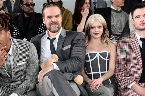 David Harbor cuddles a teddy bear at the Thom Browne fashion show with Maisie Williams & Danai Gurira